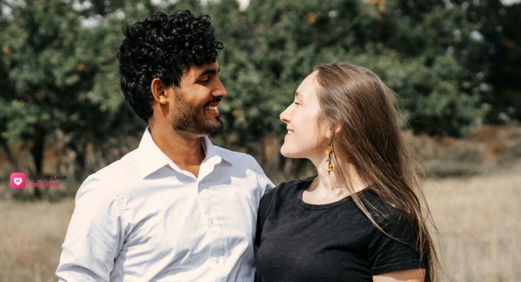 A happy couple walking together down a scenic park path, showing a secure relationship built on companionate love and mutual respect.