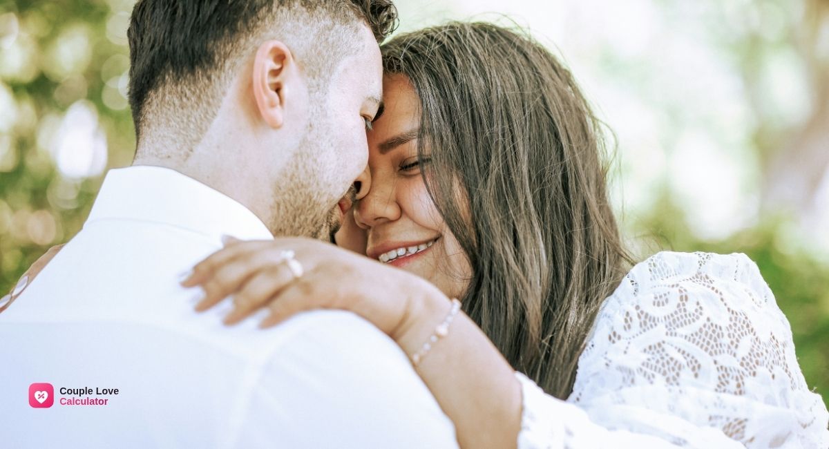 A relaxed couple resting together by a bright window, showcasing the physical calm of emotional safety in relationships.